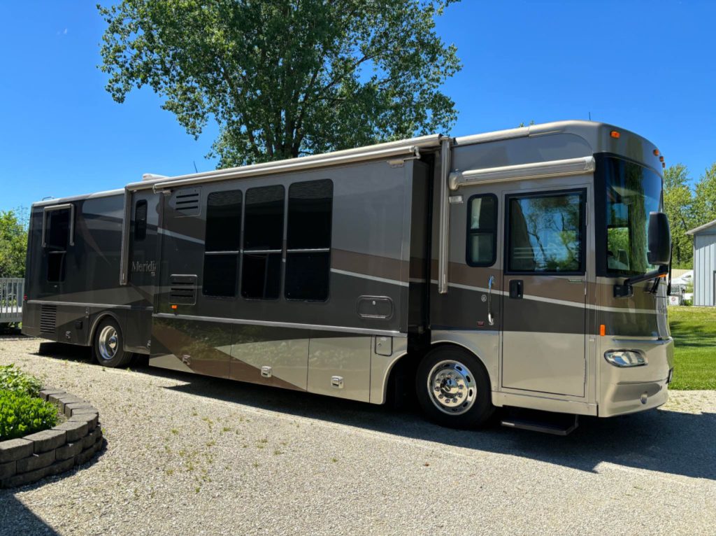 Luxurious Class A RV parked at a scenic campsite, perfect for rental adventures with Northern Lights Recreation