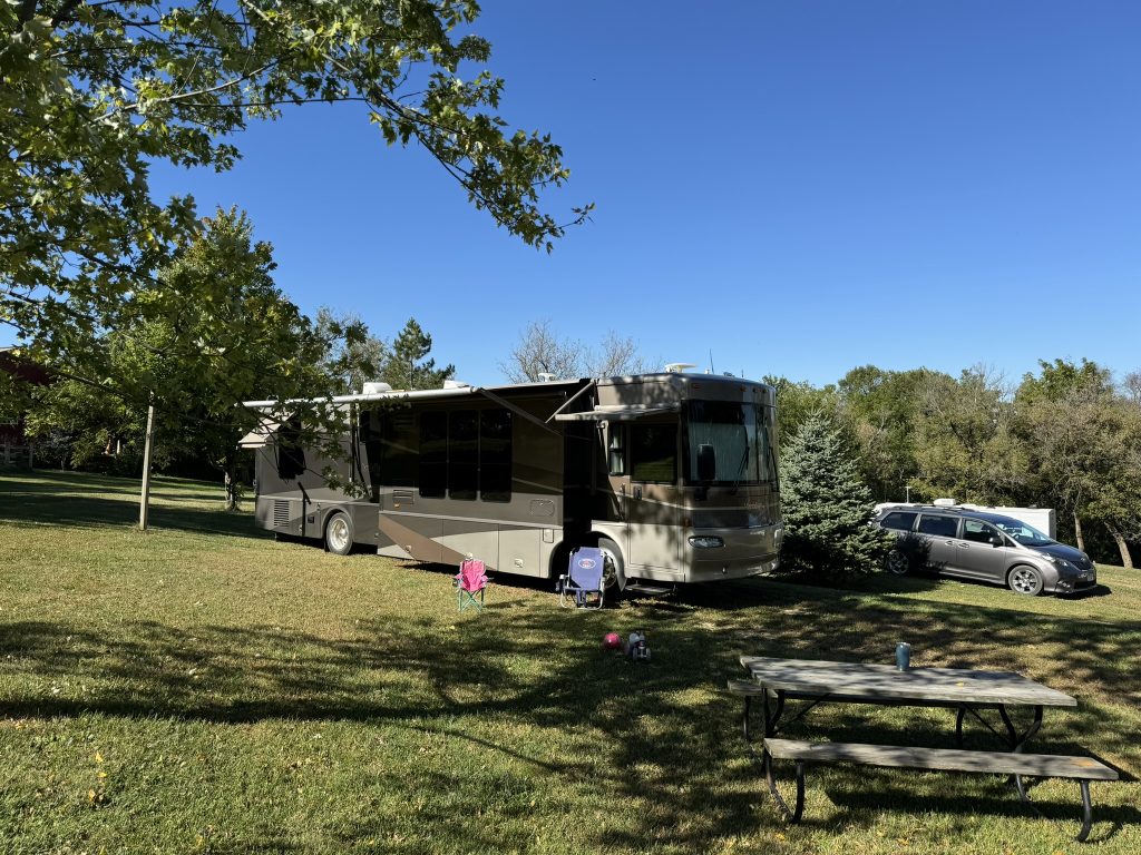 Luxurious Class A RV parked at a scenic campsite, perfect for rental adventures with Northern Lights Recreation